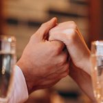 Couple-holding-hands-in-promising-posture